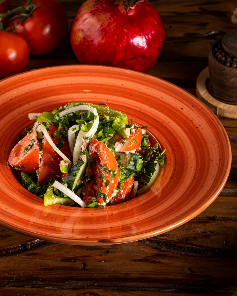 Georgian cucumber and tomato salad in an orange bowl at 1001 Nights