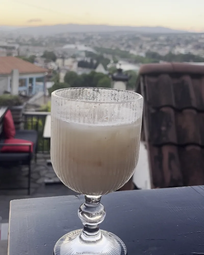 Milky cocktail in a textured stemmed glass at 144 Stairs
