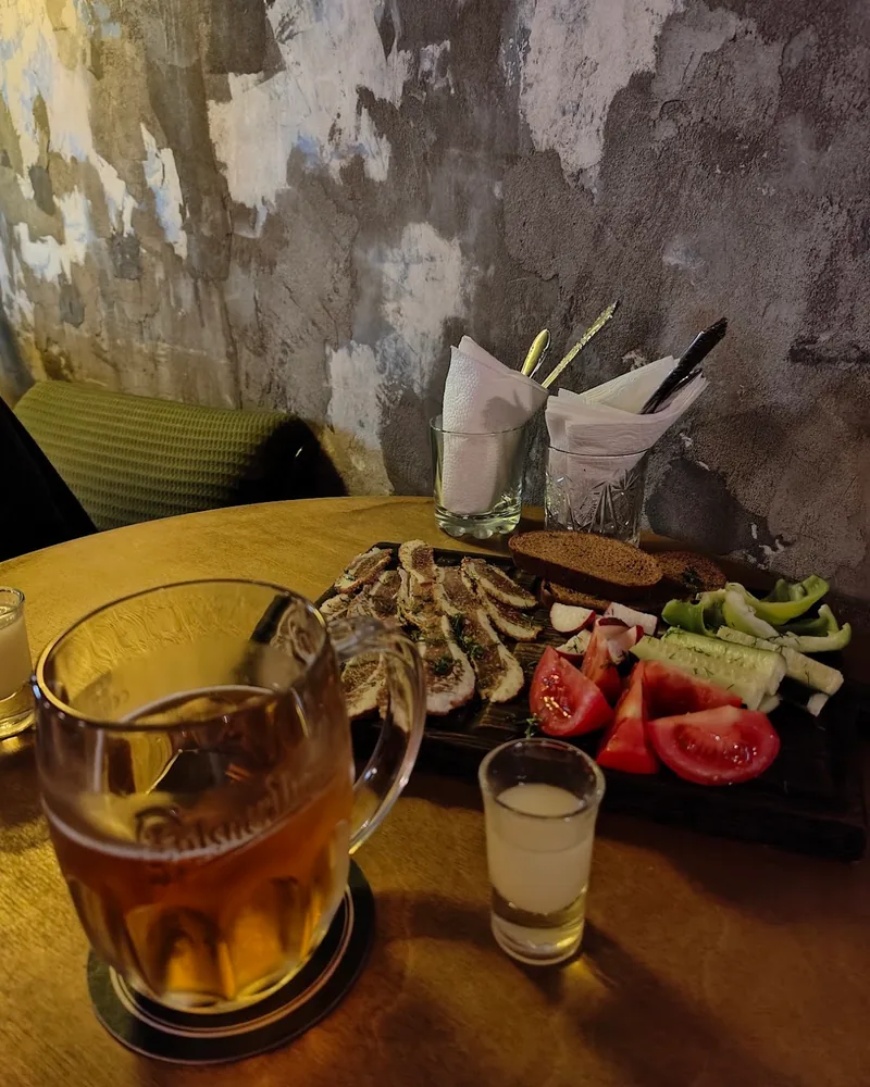 Mug of beer with a shot glass and a snack platter at 5327°