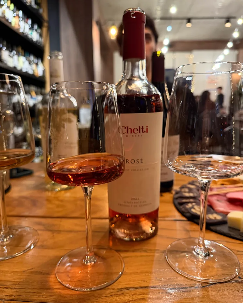 Glass of rosé wine with bottle at 8000 Vintages