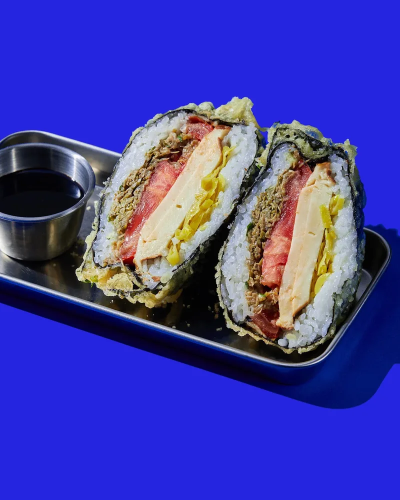Deep-fried onigirazu cut in half on a metal tray at 808