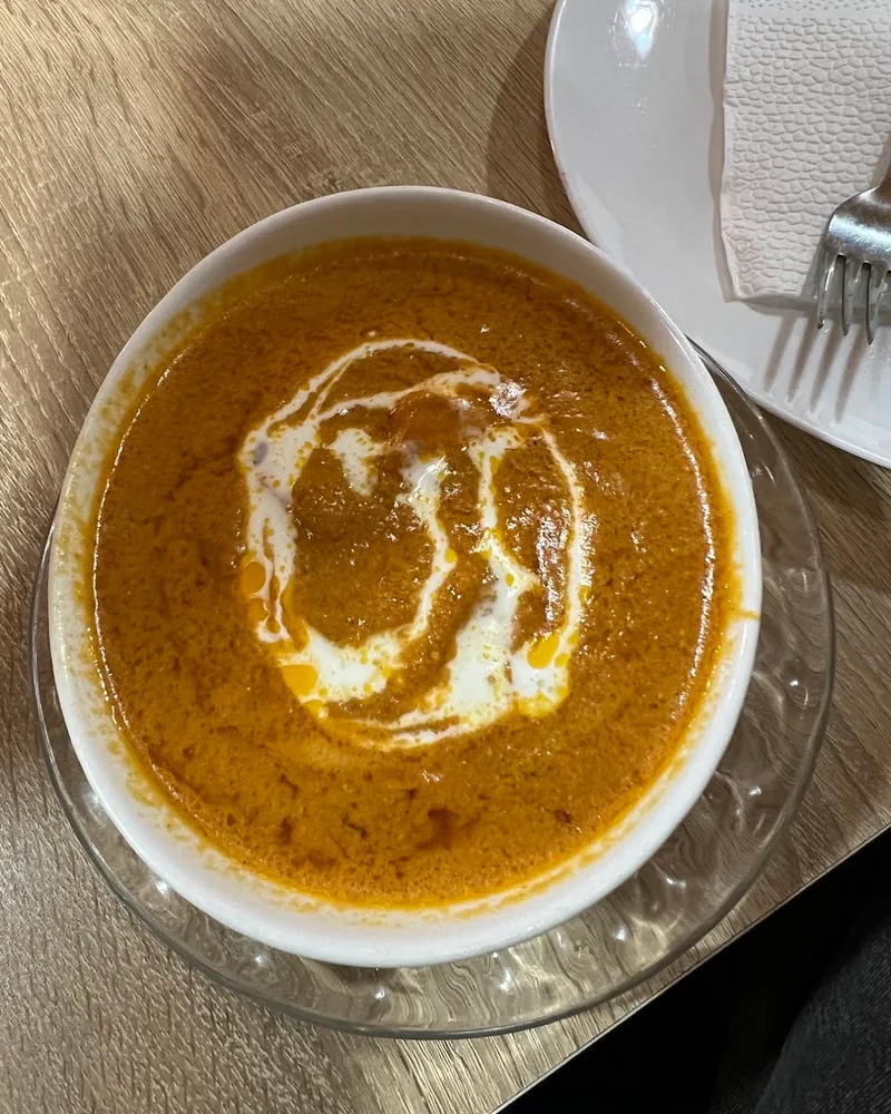 Bowl of curry with a cream swirl at Al Mecca