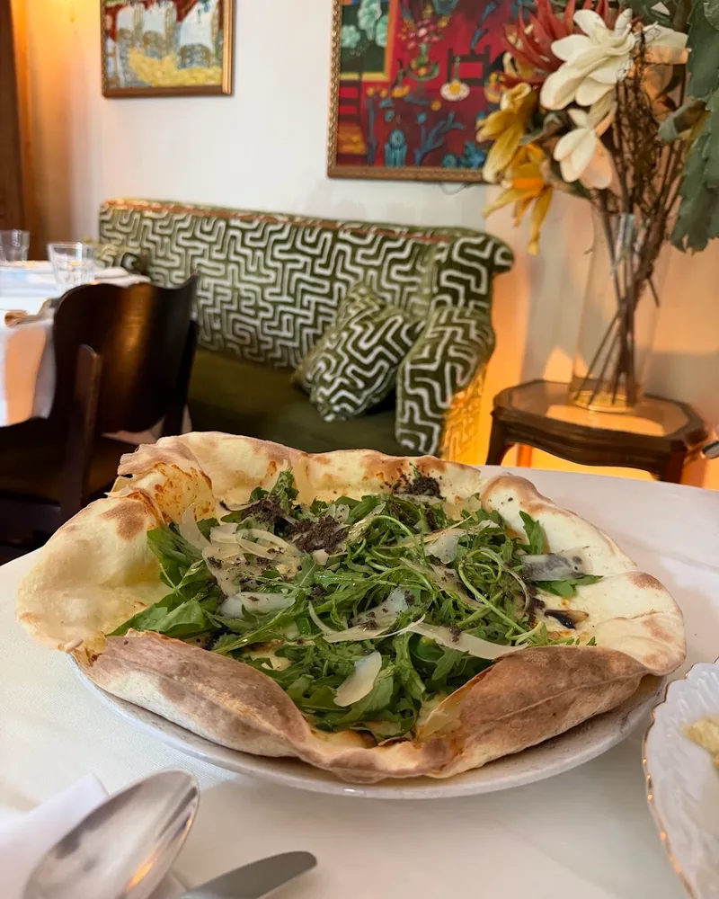 Pizza topped with rocket and shaved cheese at Ambrosiano