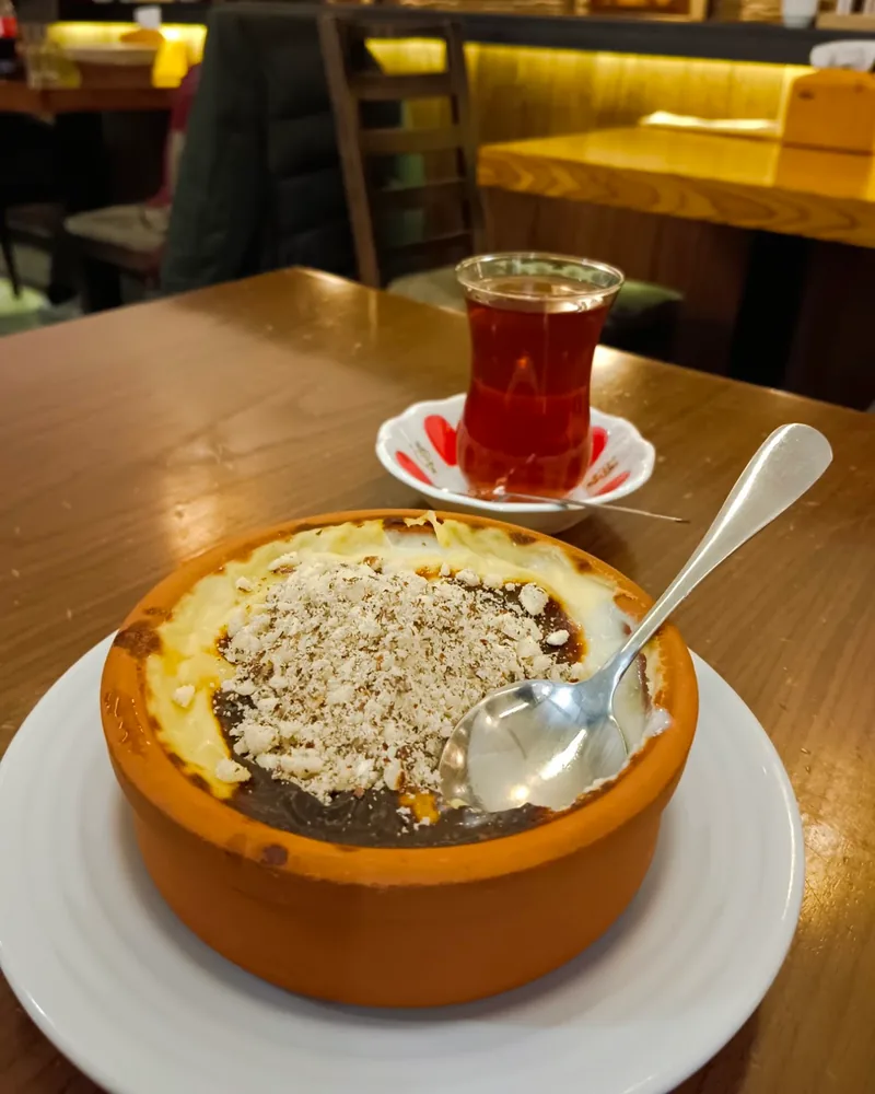 Sütlaç topped with crushed nuts served with Turkish tea at Ankara Style