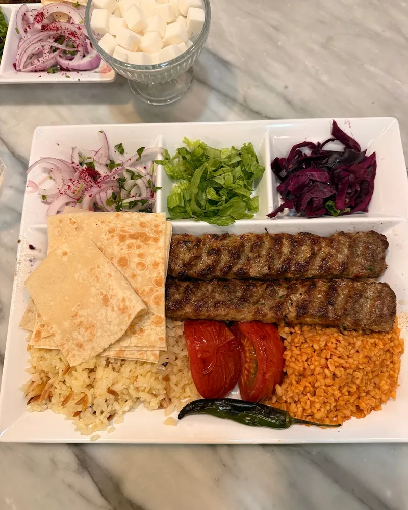 Adana kebab platter with rice, bulgur, salads and flatbread at Ankara Style