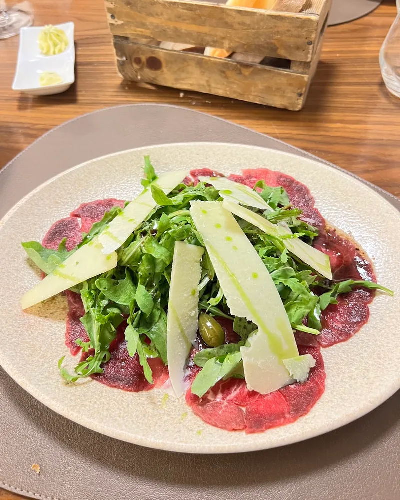 Beef carpaccio with arugula and parmesan at Asado Steakhouse