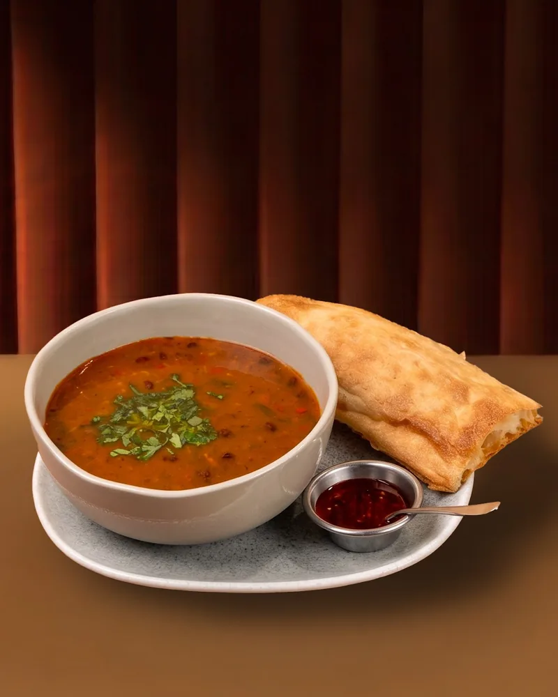 Bowl of soup with bread and sauce at Asi Khinkali