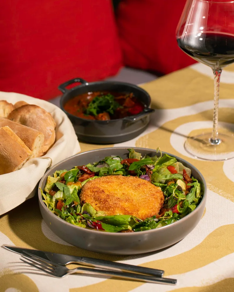Fried cheese cutlet over mixed salad at Badagoni