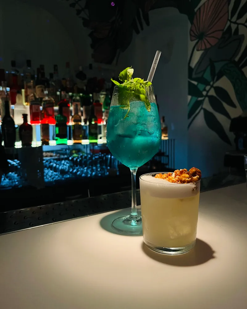 Cocktails on bar counter with back bar background at Barbar'a