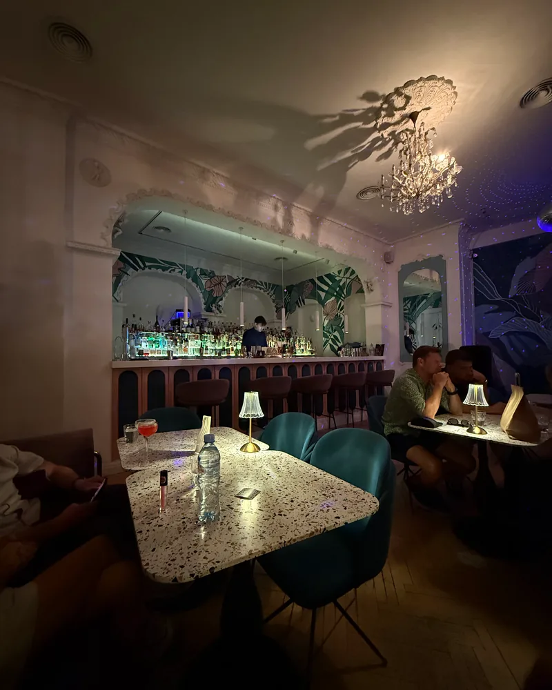 Cocktail bar seating and back bar under archway at Barbar'a