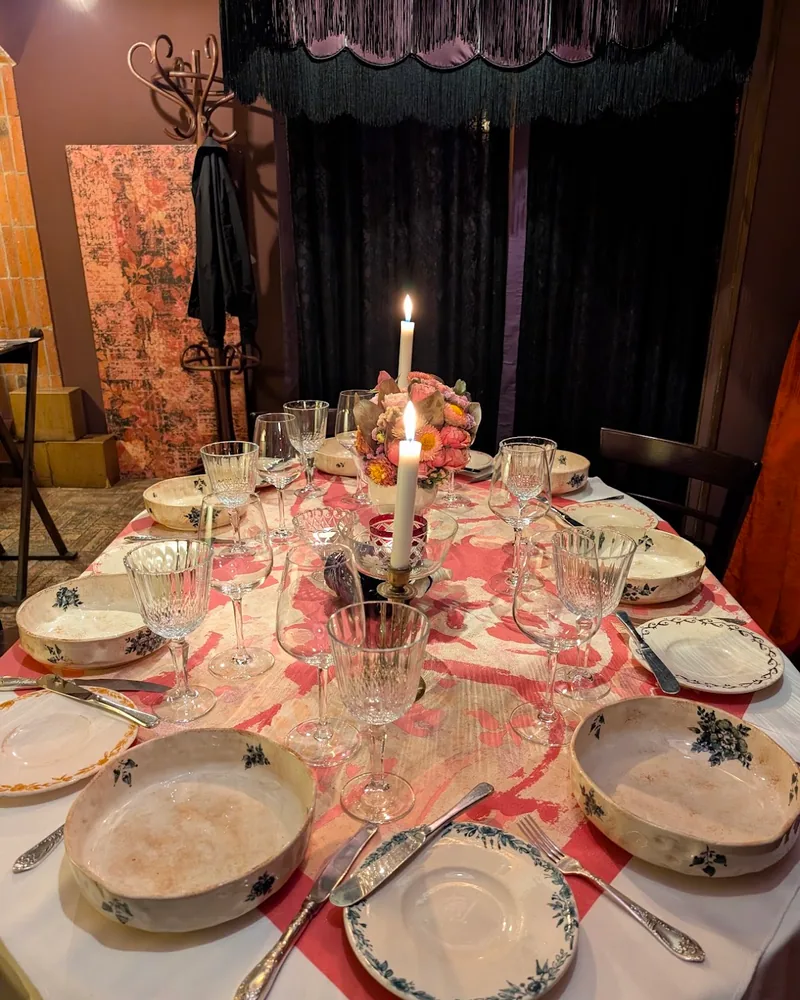 Set dining table with candles and vintage tableware at Barbarestan
