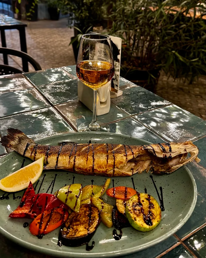 Whole grilled fish with vegetables and white wine at Barbatus