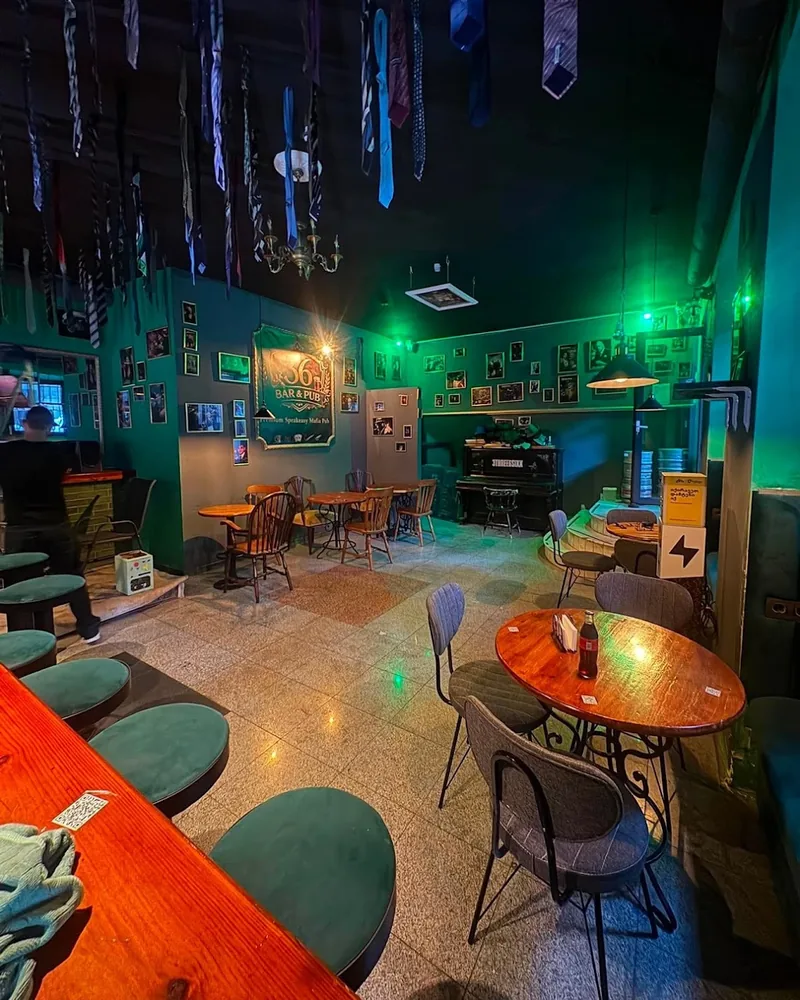 Eclectic pub interior with ties hanging from ceiling at Bar 36
