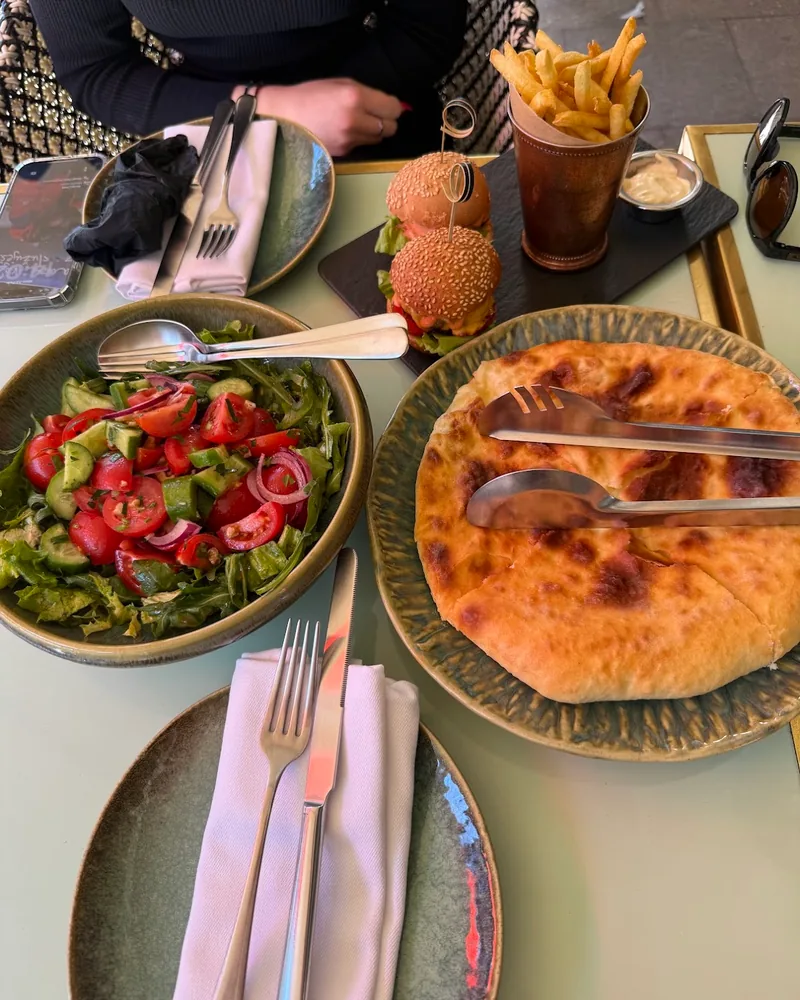 Spread with tomato cucumber salad, khachapuri and mini burgers at Bazzar Restaurant