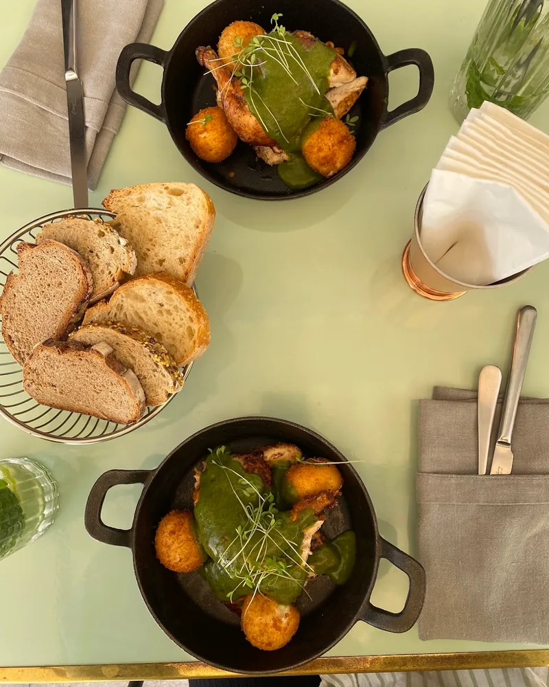 Chicken in green sauce with croquettes and sliced bread at Bazzar Restaurant