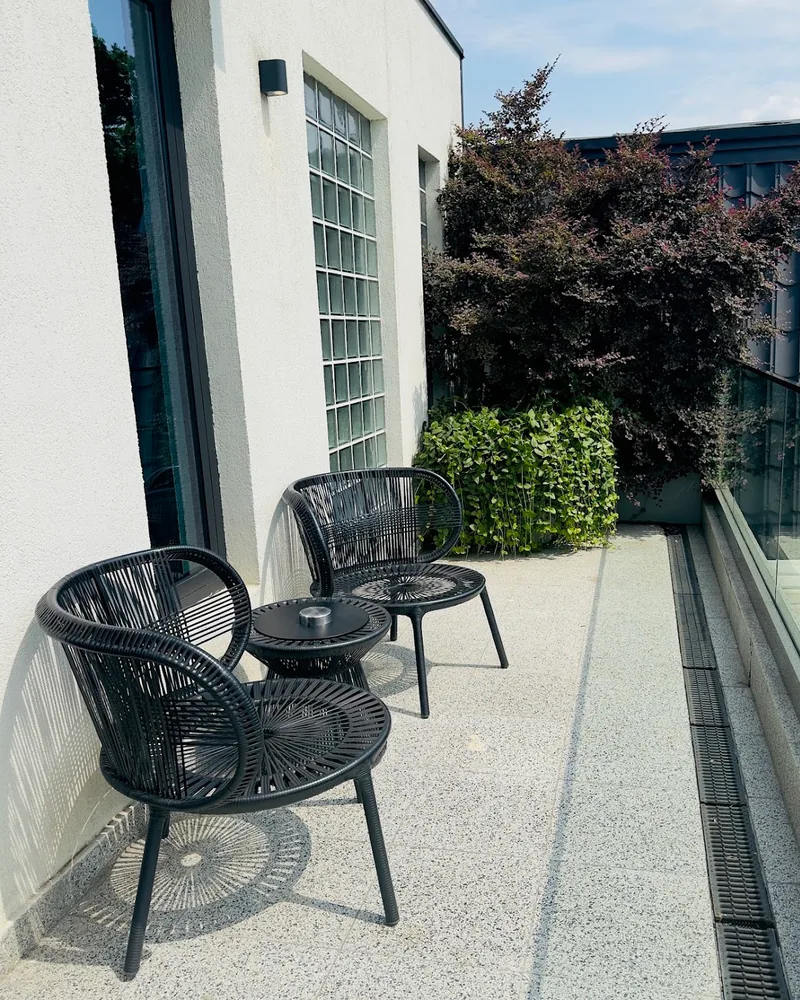 Balcony terrace with black woven chairs at Bazzar Restaurant