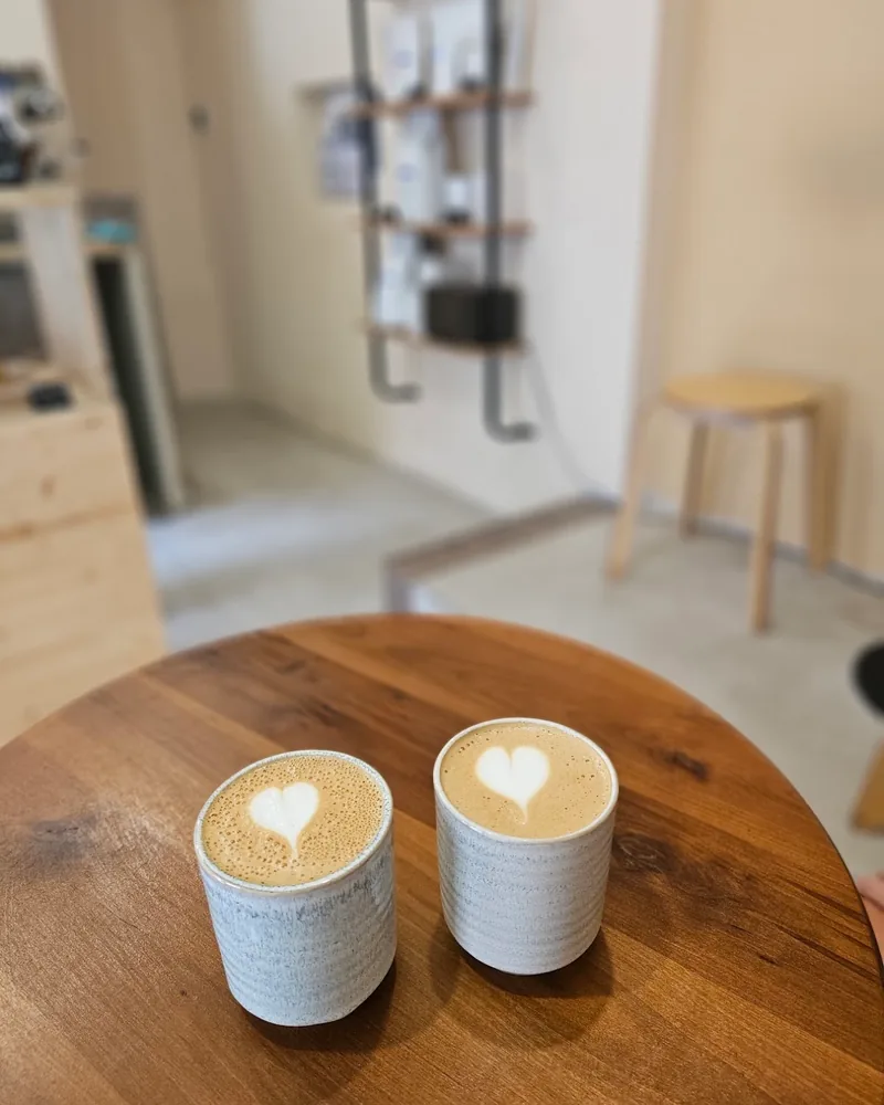 Two cups of flat white with heart latte art at Beanbourbon Roasters