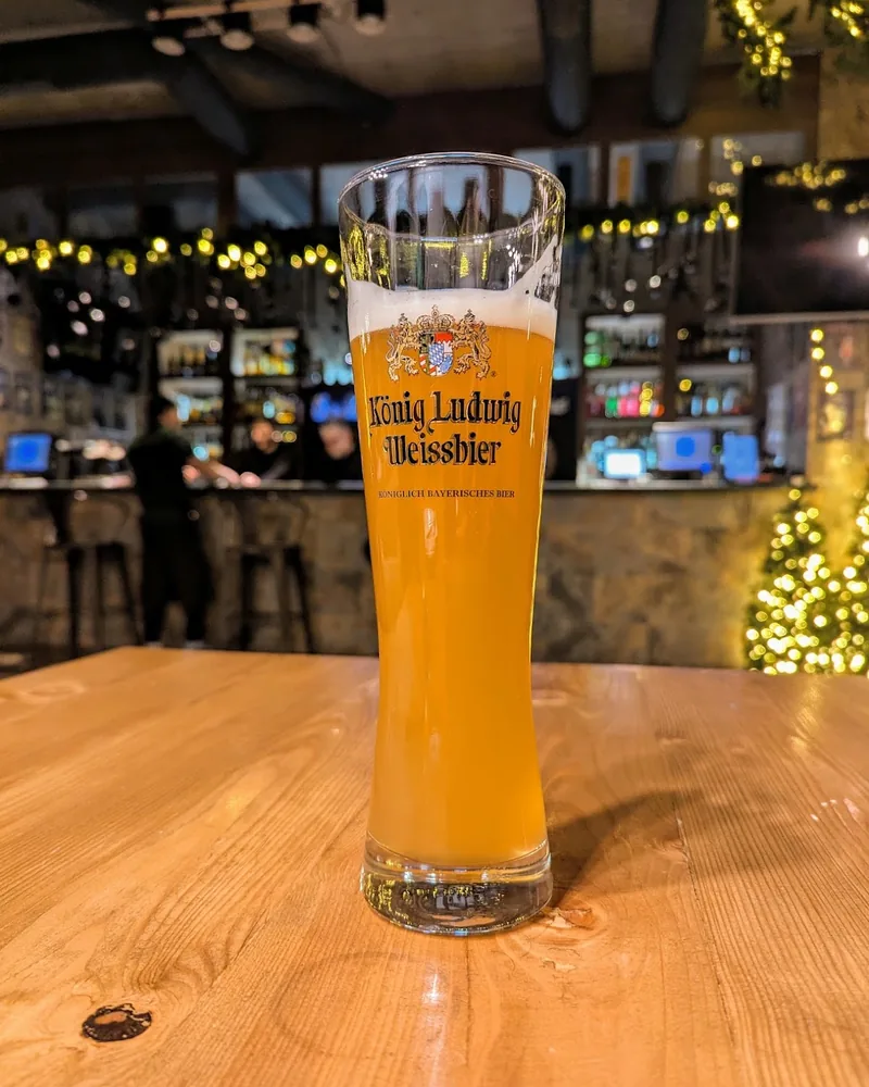 Wheat beer in a tall branded weizen glass at Beer Time