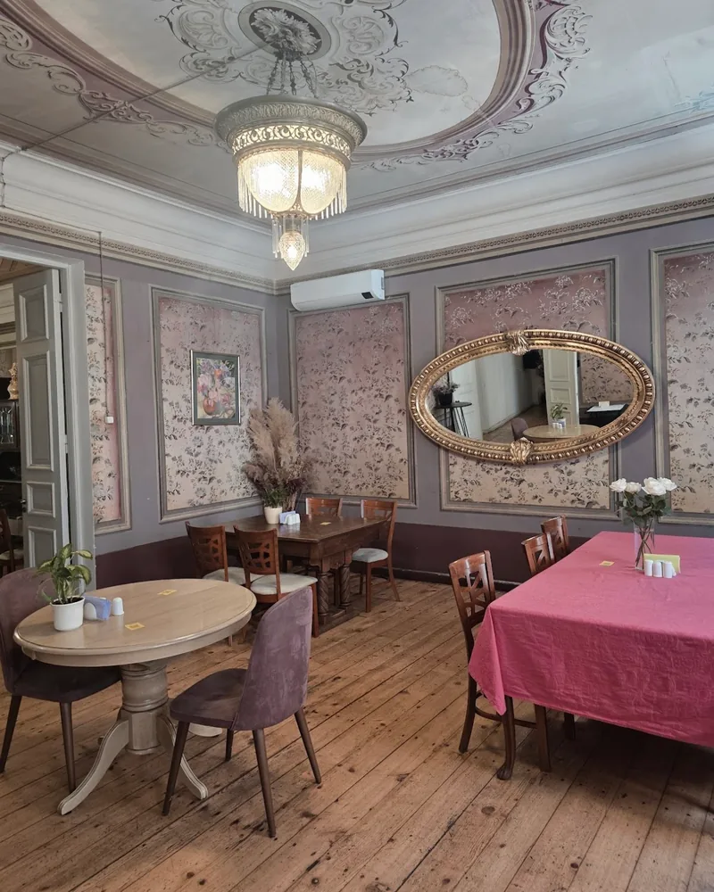 Dining room with ornate ceiling fresco and chandelier at Beletage Restaurant