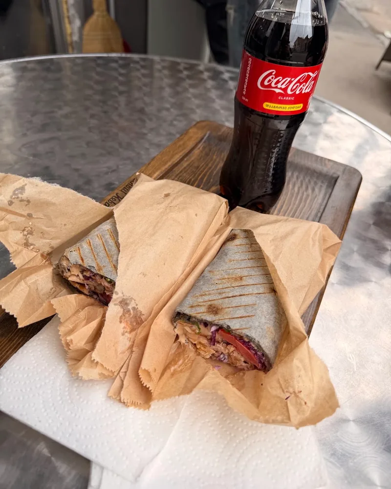 Shawarma cut in half with a bottle of Coca-Cola at Berlin Shaurma