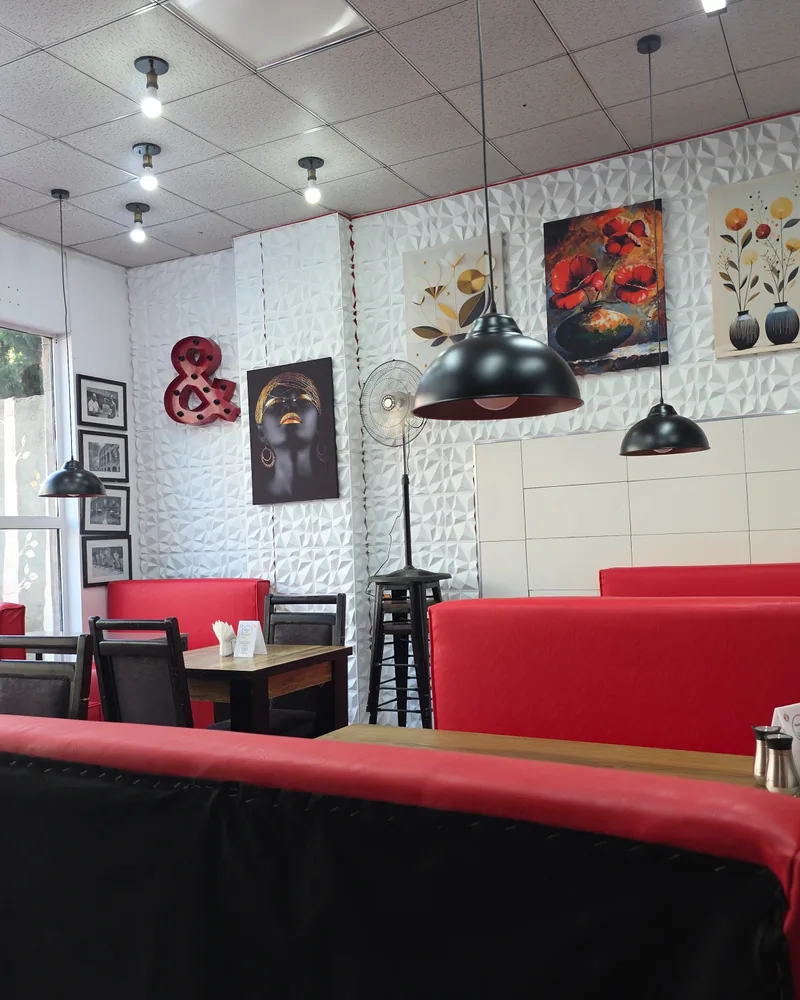 Dining area with red booths at Best Pizza in Tbilisi