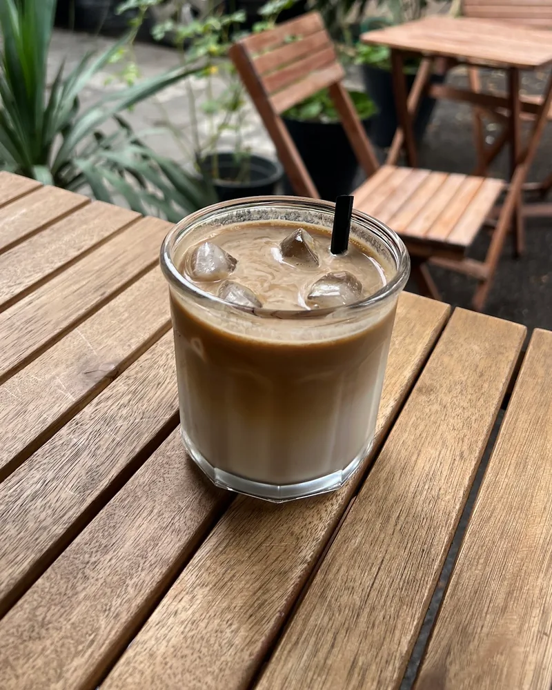 Iced latte in a short faceted glass at Black Cup