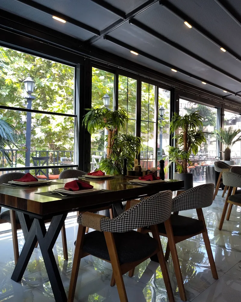 Covered terrace dining room with large windows at Bosphorus Steakhouse & Terrace
