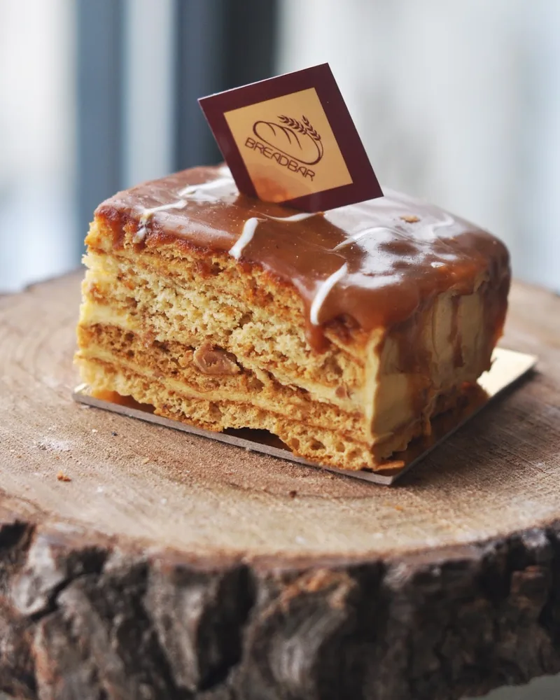 Slice of honey cake with caramel glaze at Breadbar Bakery