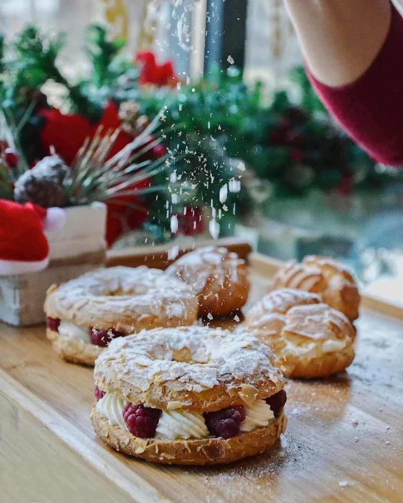 Pastries filled with cream and raspberries dusted with powdered sugar at Breadbar Bakery