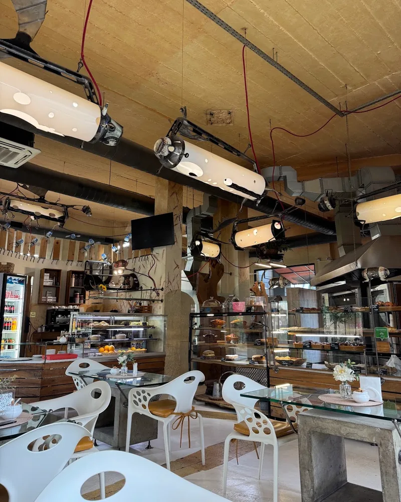 Bakery dining room with industrial lights and display cases at Breadbar Bakery