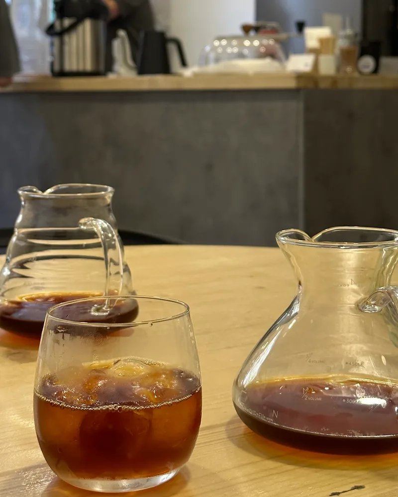 Iced filter coffee and carafes on a wooden table at Brewio