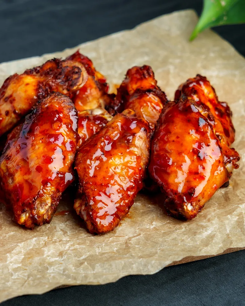 Glazed chicken wings with dipping sauce at Burger Space