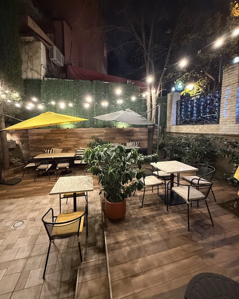 Outdoor courtyard patio with string lights and tables at Burger Space