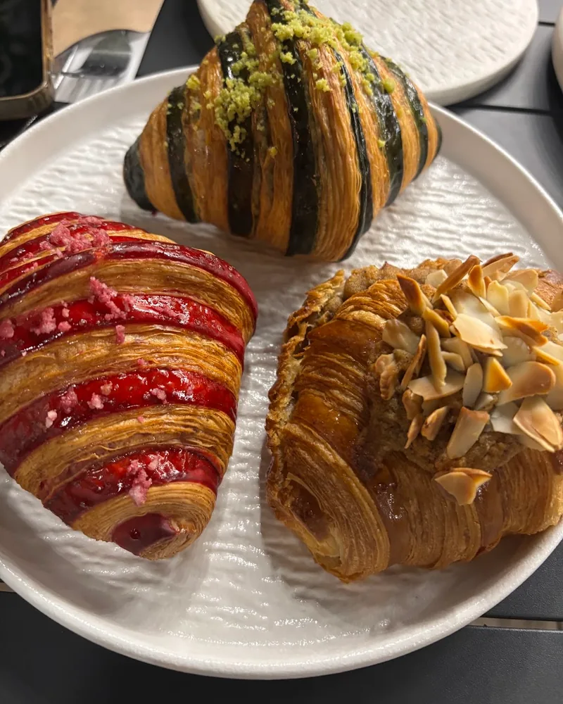 Assorted croissants on a ceramic plate at Cafe 43