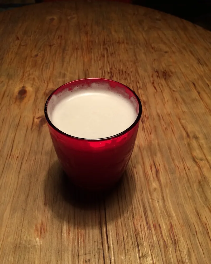 White drink in a red glass at Cafe Gallery