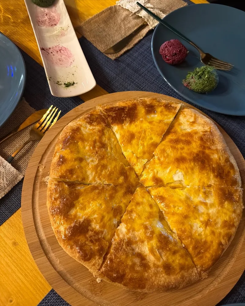 Imeretian khachapuri on a wooden board at Cafe Nice