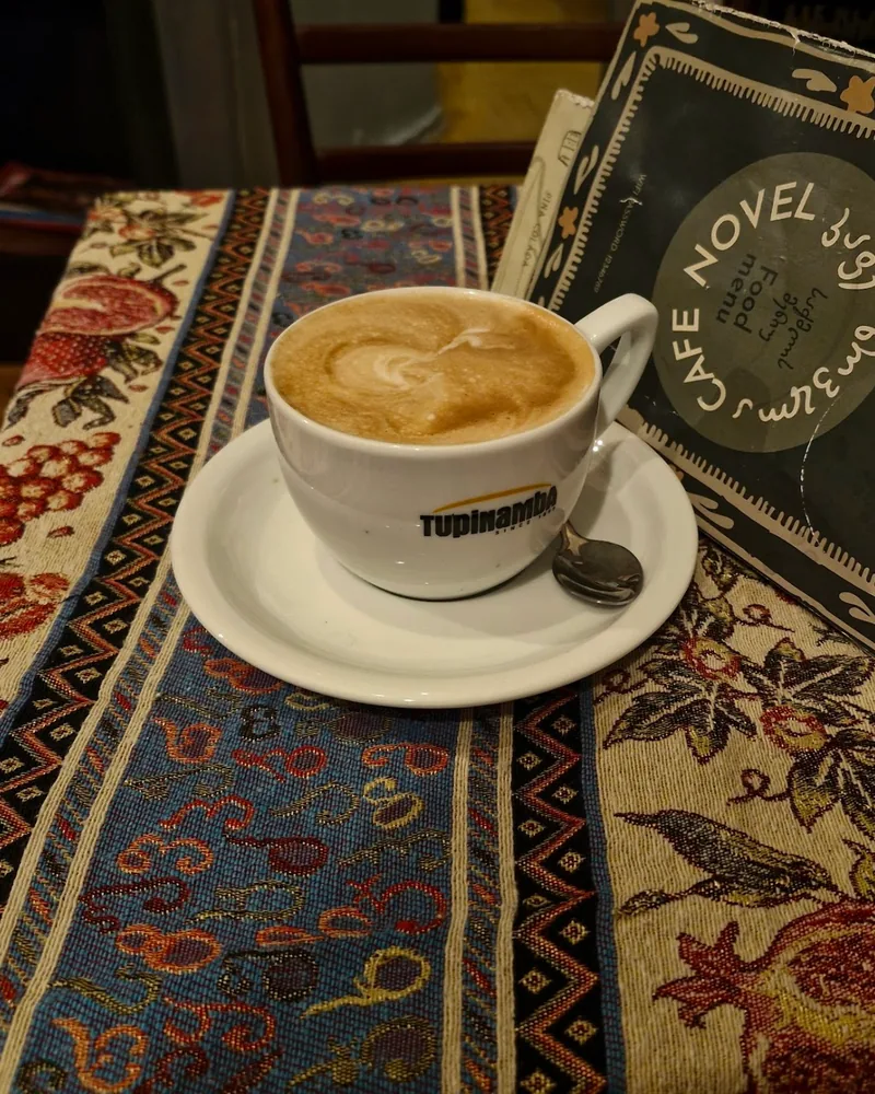 Cappuccino in a white cup on a saucer at Cafe Novel