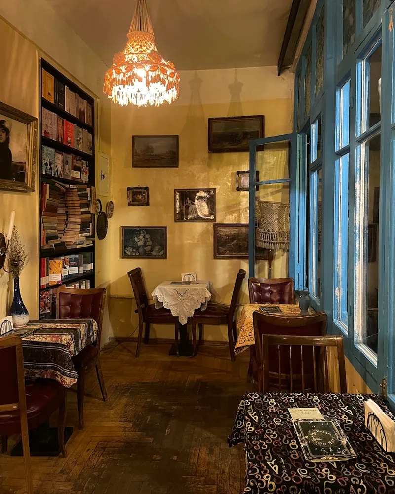 Vintage cafe interior with books and chandelier at Cafe Novel