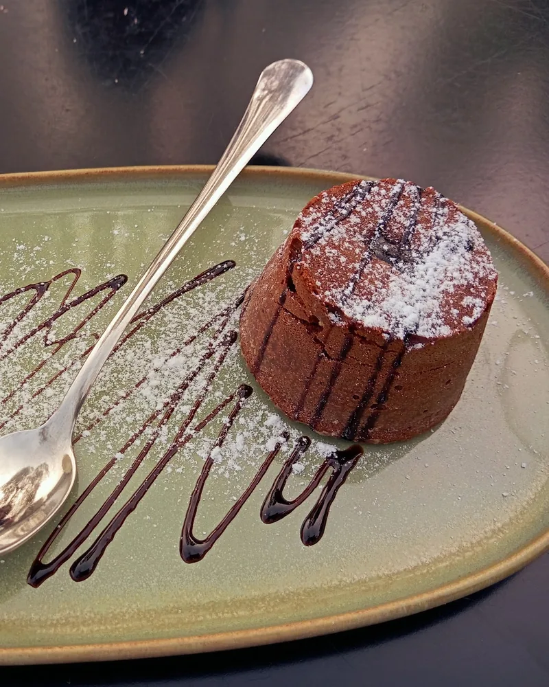 Chocolate fondant with vanilla ice cream on an oval plate at Cafe Verde