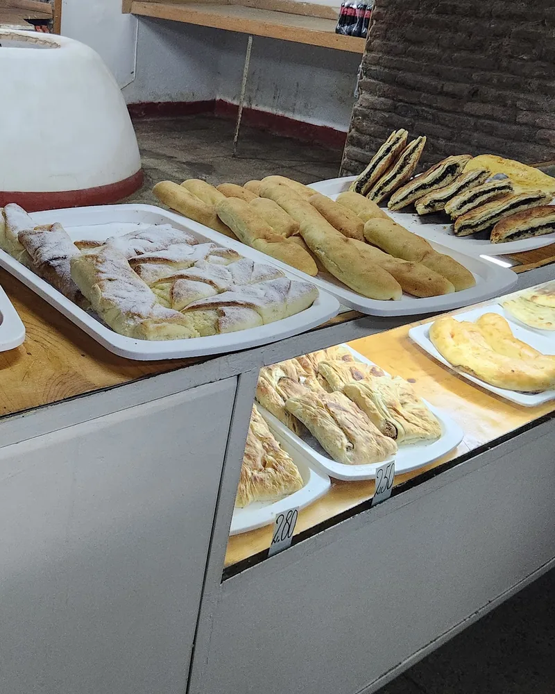 Trays of baked goods and pastries on the bakery counter at Caravanserai Bakery