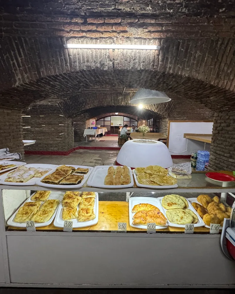 Brick-vaulted bakery counter with pastries at Caravanserai Bakery