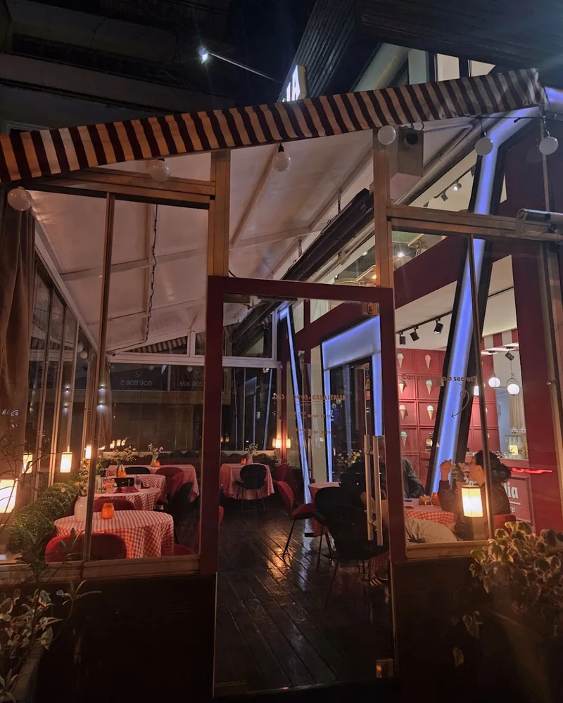 Enclosed terrace dining area at night at Casa Italia