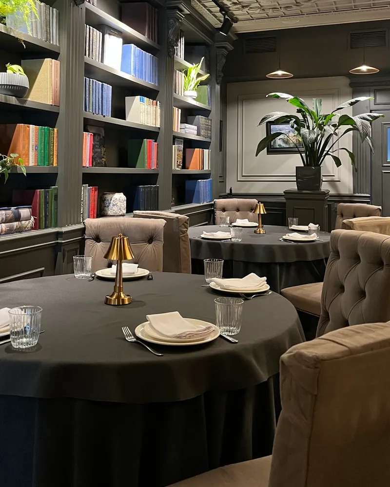Dining room with bookshelves and coffered ceiling at Charru Grill & Restaurant