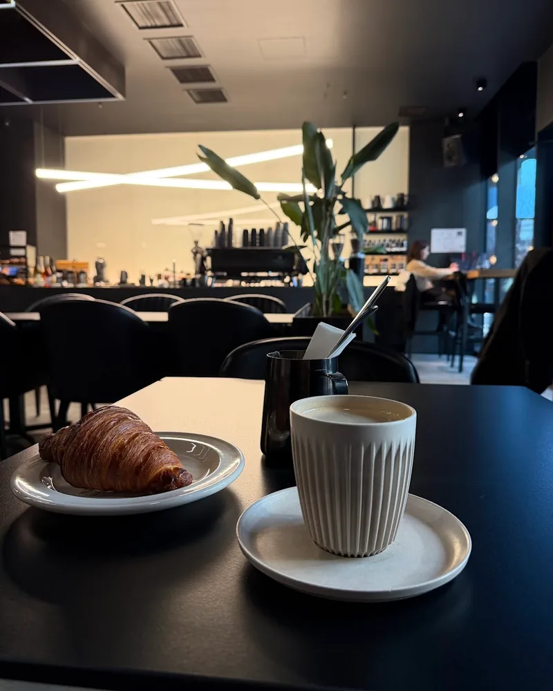 Coffee in a ceramic ribbed cup beside a croissant at Coffee Lab (Chavchavadze Ave)