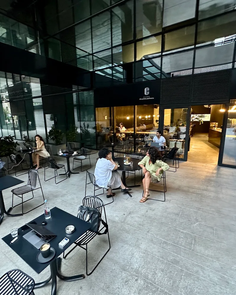 Outdoor patio seating outside modern glass building at Coffee Lab (Chavchavadze Ave)