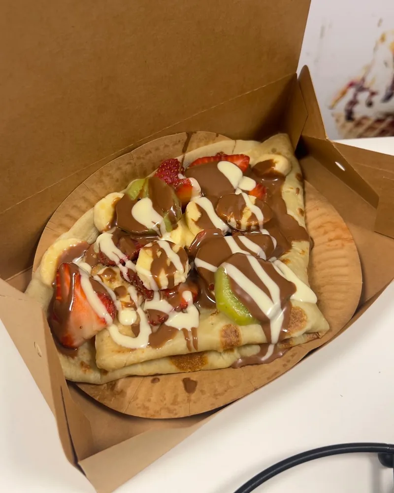 Crepe topped with chocolate, strawberries, bananas and kiwi at Cherry Land