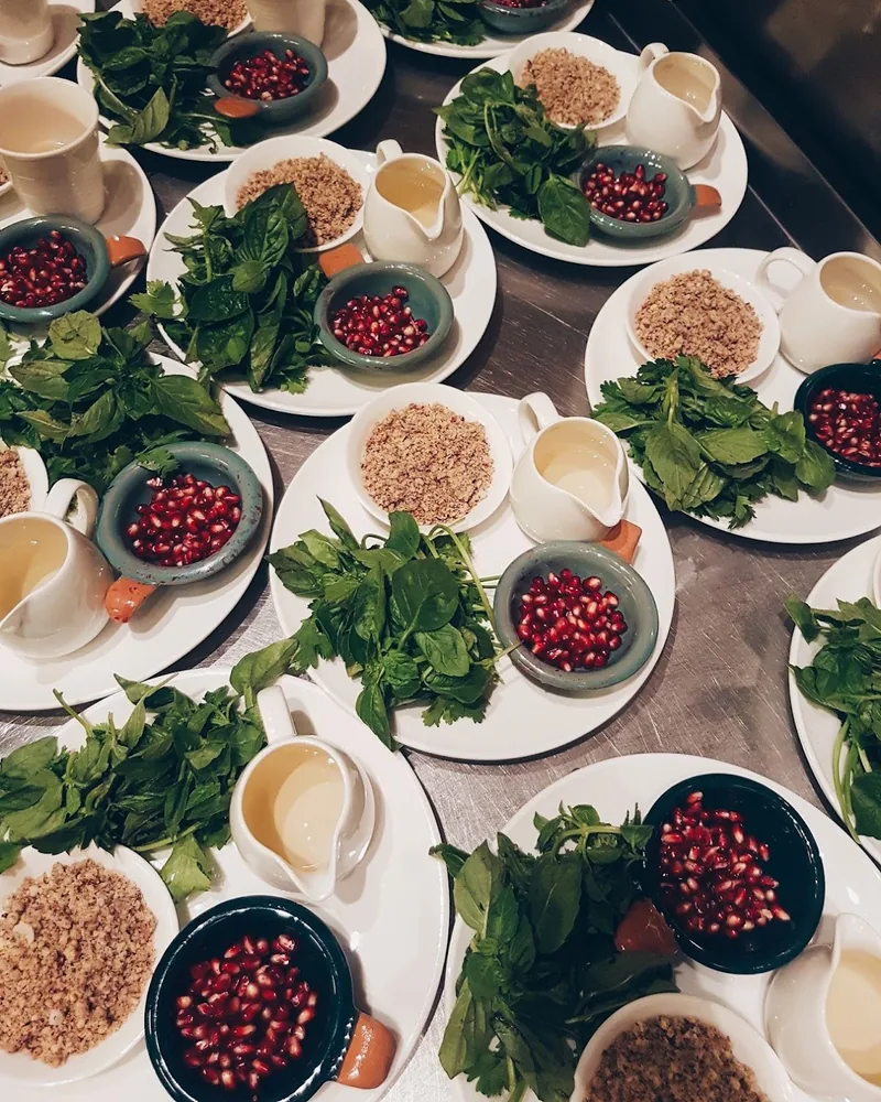 Cooking class ingredients prepped on plates with herbs, pomegranate and walnuts at Culinarium Cooking School