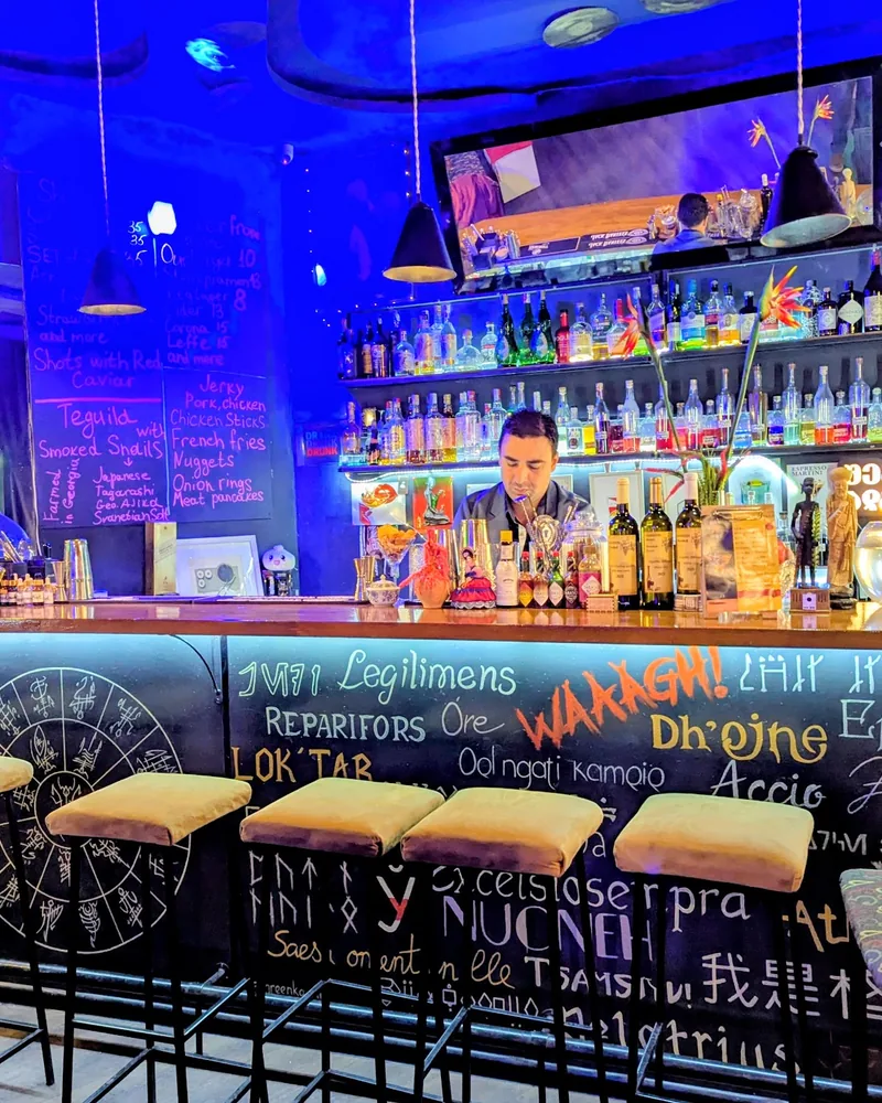 Illuminated bar counter with fantasy script and back bar at D22 Bar