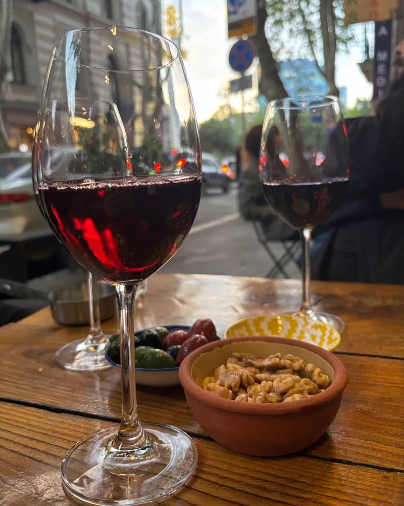 Glass of red wine on an outdoor table at DADI Wine Bar & Shop