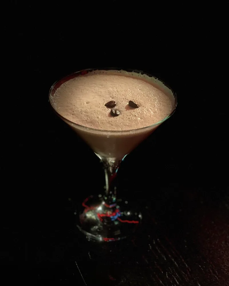 Espresso martini garnished with coffee beans in a coupe at Dallas Pub